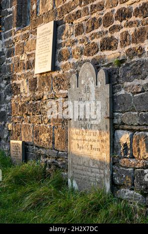 Gravestones along the walls of the church of St Michael de Rupe on the summit of Brent Tor in Dartmoor Devon UK Stock Photo