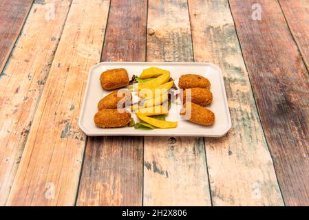 Serrano ham croquettes serving with homemade chips served as tapas in a Spanish restaurant Stock Photo