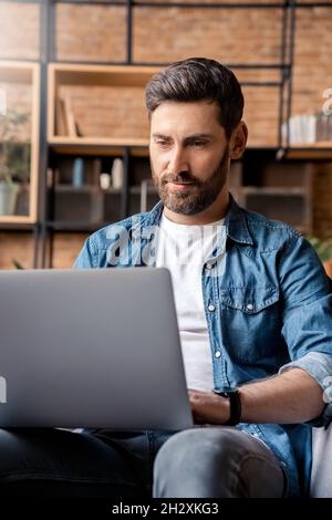 Handsome caucasian man videoconferencing chatting online using laptop computer Stock Photo
