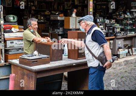 Elderly man selling used AV equipment on Clivio Portuense, next to Mercato di Porta Portese, in Trastevere district of Rome, Italy Stock Photo