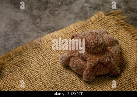 The sweet bread called Bread of the Dead (Pan de Muerto) on the brown sacking Stock Photo