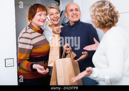 Mature friends are visiting their friend Stock Photo