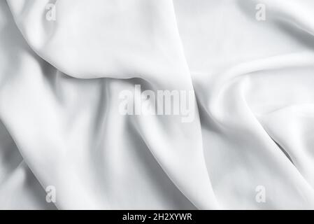 Crumpled textile fabric background of light grey color. Stock Photo