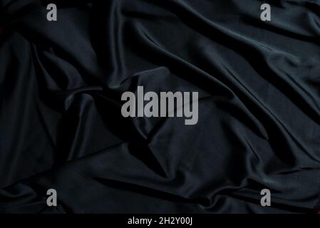 Crumpled textile fabric background of black color. Stock Photo