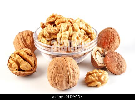 fresh kernels, broken and whole walnuts close-up isolated on white background Stock Photo