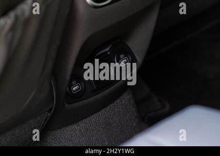 12V and 220v power outlet socket in the car. Opened sockets. Stock Photo