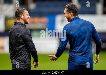 Luton, UK. 25th June, 2021. Ex Luton Town player, George Moncur (18) of Hull City chats to Goalkeeper James Shea (1) of Luton Town during the half time break during the Sky Bet Championship match between Luton Town and Hull City at Kenilworth Road, Luton, England on 23 October 2021. Photo by David Horn. Credit: PRiME Media Images/Alamy Live News Stock Photo