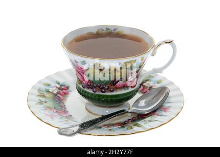 Antique cup and saucer with fruit pattern decoration - white background Stock Photo