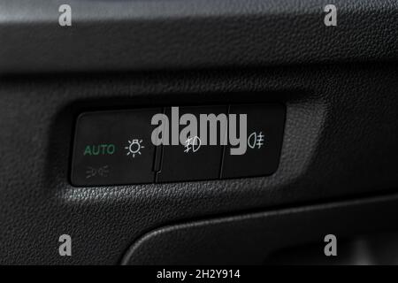 Car fog lights switch close up. Control switch power light system. Lights control panel in car Stock Photo
