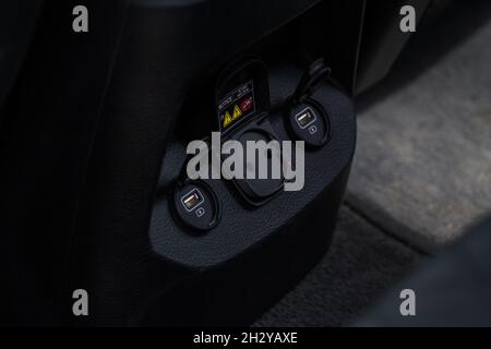 12V and 220v power outlet socket in the car. Opened sockets. Stock Photo