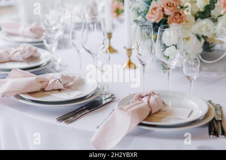 Decorating the wedding table with flowers and beautiful table setting Stock Photo