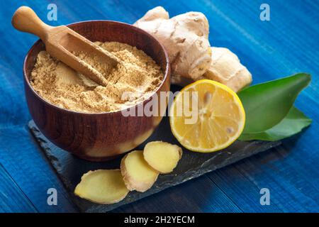 ginger root and powder on black stone plate Stock Photo