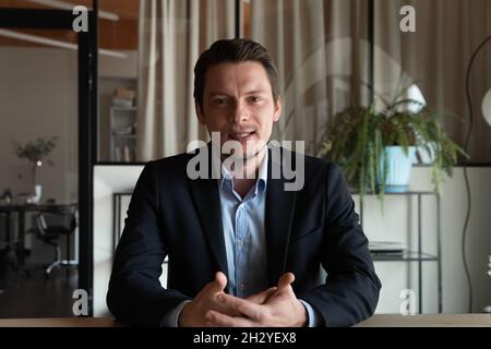 Confident young businessman professional speaker broadcast live coaching seminar online Stock Photo
