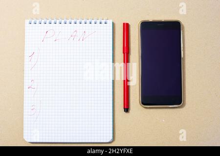 notepad, red marker and phone, top view Stock Photo