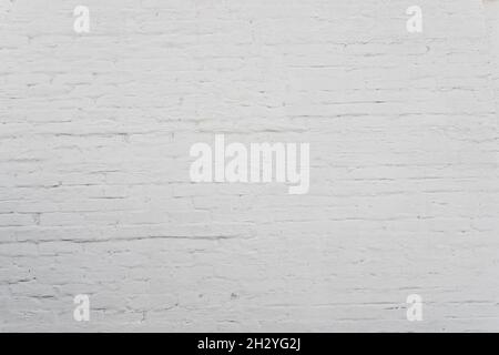 White brick wall background in rural room. Simple grungy white brick wall as seamless pattern texture background. Stock Photo