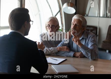 Annoyed mature spouses scam victims complain lawyer on commercial fraud Stock Photo