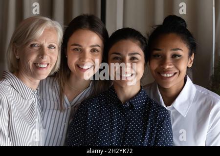 Team portrait four females coworkers of different age ethnic group Stock Photo