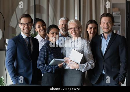 Old and young age multiethnic corporate staff look at camera Stock Photo