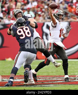 Tampa, United States. 24th Oct, 2021. Tampa Bay Buccaneers' Alex Cappa (C) blocks Chicago Bears' Bilal Nichols (98) as Tampa Bay quarterback Tom Brady (12) throws from the pocket during the first half at Raymond James Stadium in Tampa, Florida on Sunday, October 24, 2021. Photo by Steve Nesius/UPI Credit: UPI/Alamy Live News Stock Photo