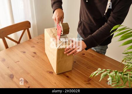 A person packing a package to make a shipment Stock Photo