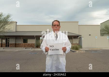 Physician activist holds sign in protest against covid vaccine mandate Stock Photo