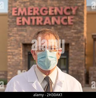 Tired looking ER physician portrait wearing mask during coronavirus pandemic