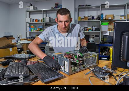 Computer technician working in workshop Stock Photo