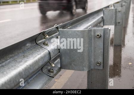 underscrewed nuts and bolts in highway road railing Stock Photo