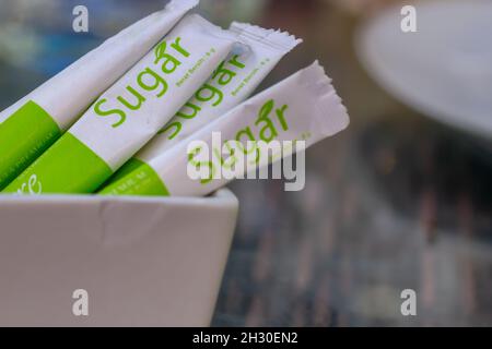 Premium granulated sugar from sugar cane for sweetening is served at the table of a cafe in a tourism area. Stock Photo
