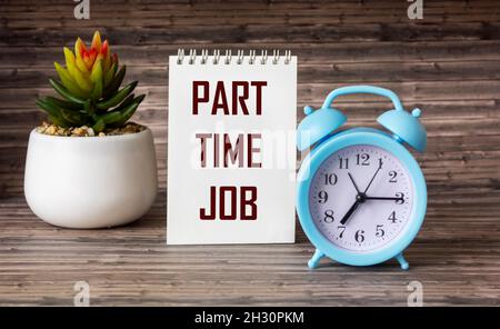 part time job text written on notepad and wooden table with clock and cactus flower Stock Photo