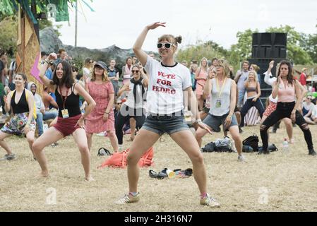 Festival goers take part in a dance class at Glastonbury Festival, Worthy Farm, Somerset at Worthy Farm, Somerset Stock Photo