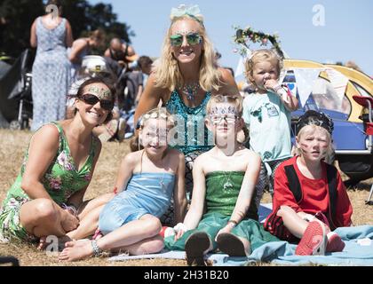 Festival goers relax in the MainStage arena at Camp Bestival 2018, Lulworth Castle, Wareham. Picture date: Saturday 28h July 2018. Photo credit should read: David Jensen/EMPICS Entertainment Stock Photo