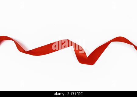 red satin ribbon on white background. Stock Photo
