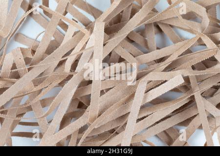 Torn paper strips close-up. A bunch of shredded cardboard. Stock Photo