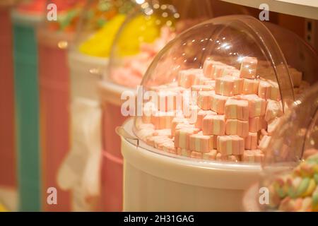 Multicolored marshmallows in beautiful containers. Sale of sweets. Stock Photo