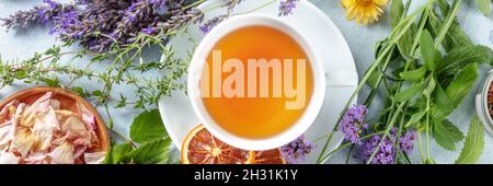 Tea panorama with herbs, flowers and fruit, shot from the top. Healthy organic hot drink Stock Photo