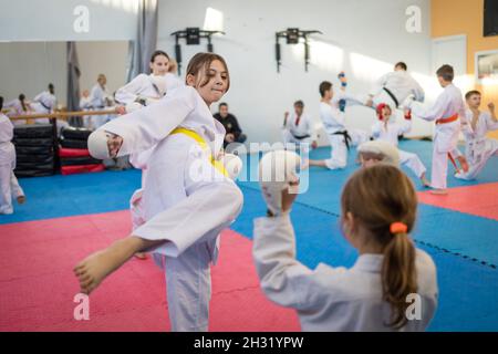 October 23, 2021, Minsk, Belarus, Shotokan Karate Technical Seminar. Girls young athletes practice kicks Stock Photo