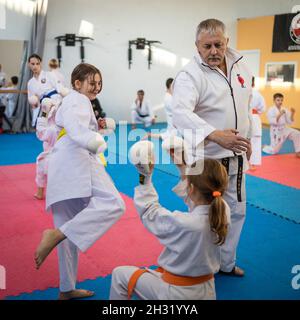 October 23, 2021, Minsk, Belarus, Shotokan Karate Technical Seminar. Girls young athletes practice kicks under the guidance of an elderly coach Stock Photo