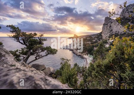 Golden sunset from Panea cliff with mountain cat koshka in background. Simeiz, Crimea. Black Sea Stock Photo
