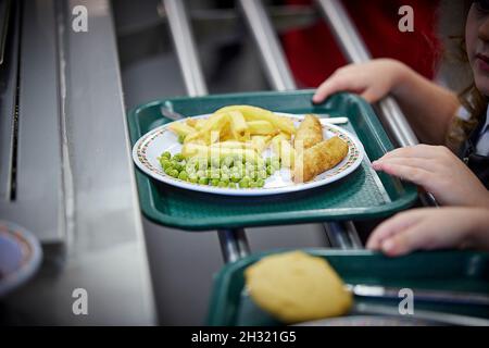 School dinners fish chips and peas on a plate Stock Photo