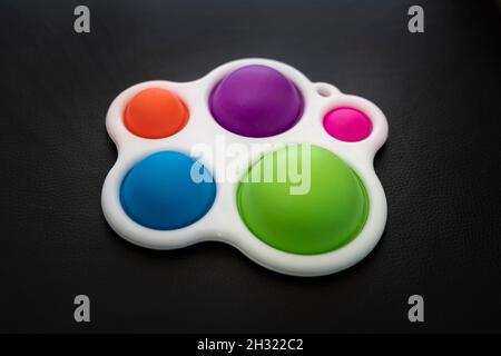 Close-up of the popular children's toy simple dimple fidget with soft focus. Macro. New popular silicone colorful pop It game. Anti-stress Stock Photo