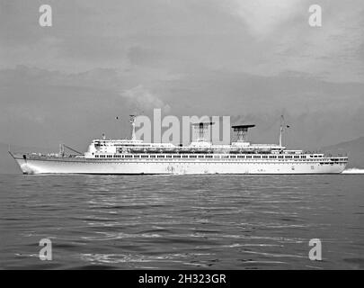 SS Michelangelo at sea in the late-1960s. The ship was an ocean liner built in 1965 for Italian Line in Genoa, Italy. She was one of the last ships to be built for the North Atlantic route, along with her sister ship was the SS Raffaello. Note the funnels, where an intricate trellis-like pipework allowed wind to pass through the funnel and a large smoke deflector fin on the top. The design proved to be very effective. The ship ended up in Bandar Abbas, Iran where she spent 15 years as a floating barracks. Plans to reconstruct her as the cruise ship came to nothing and in 1991 she was scrapped. Stock Photo