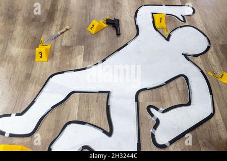 Crime scene investigation with police tape flat icon. White outline of victim gun and knife marked with number evidence markers at crime scene Stock Photo