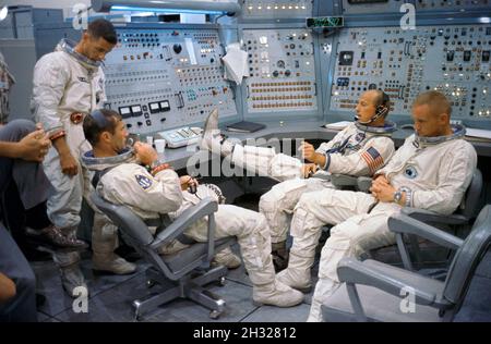 (8 Sept. 1966) --- Gemini-11 prime and backup crews are pictured at the Gemini Mission Simulator at Cape Kennedy, Florida. Left to right are astronauts William A. Anders, backup crew pilot; Richard F. Gordon Jr., prime crew pilot; Charles Conrad Jr. (foot on desk), prime crew command pilot; and Neil A. Armstrong, backup crew command pilot. Stock Photo