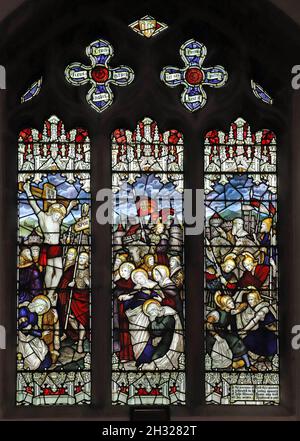A stained glass window by the Kempe Studio: The Crucifixion of Christ, The Parish Church of All Saints & St James, King's Cliffe, Northamptonshire Stock Photo