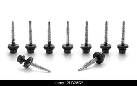 Black screws on metal isolated on white background. Screws for roofing material. Stock Photo