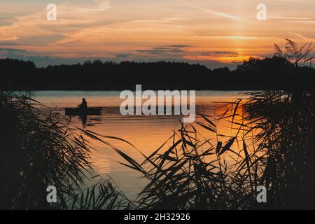 Boat on the lake during beautiful sunset, Stankow, Poland Stock Photo