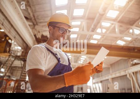 Handsome man studying architectural plan at construction site Stock Photo