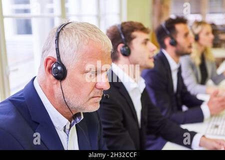 Business team people with headset during a training session for hotline in the call center Stock Photo