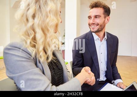 Shaking hands between two business people for greeting or congratulation Stock Photo